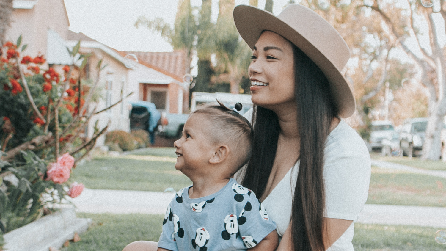 Woman wearing hat while holding child