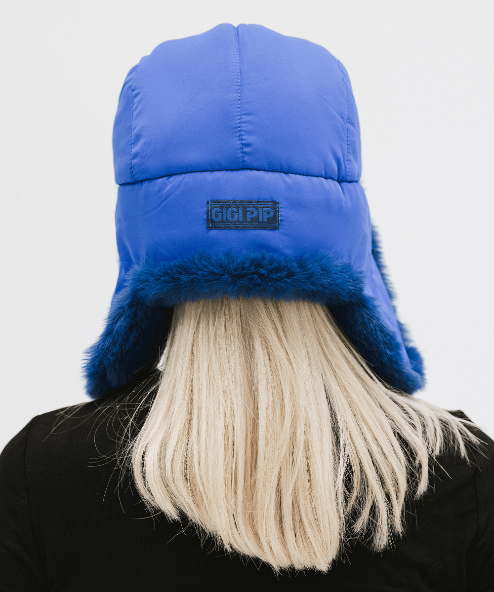 Gigi Pip winter hats for women - Leda Trapper Hat - 100% faux fur + polyester classic style inspired trapper hat featuring a retro limited edition holiday Gigi Pip logo [alpine blue]