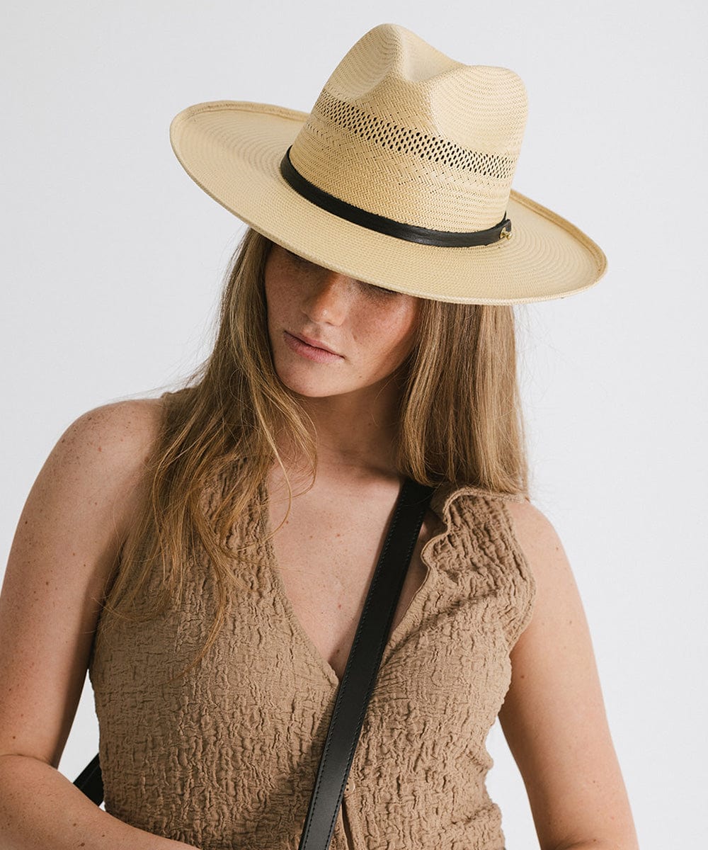 Gigi Pip panama straw for women - Saguaro Wide Brim Natural - a pinched fedora crown with a wide and slightly upturned brim, featuring a matte black leather band that is Gigi Pip embossed around the crown [natural]