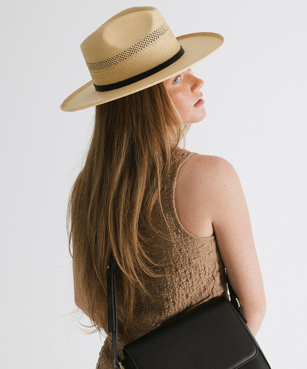 Gigi Pip panama straw for women - Saguaro Wide Brim Natural - a pinched fedora crown with a wide and slightly upturned brim, featuring a matte black leather band that is Gigi Pip embossed around the crown [natural]